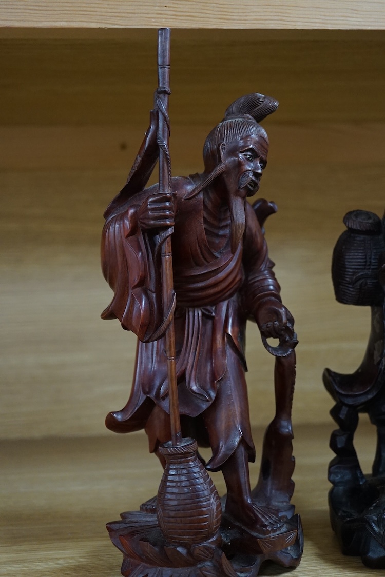 Three Chinese carved wood figures of elders, largest 37cm high